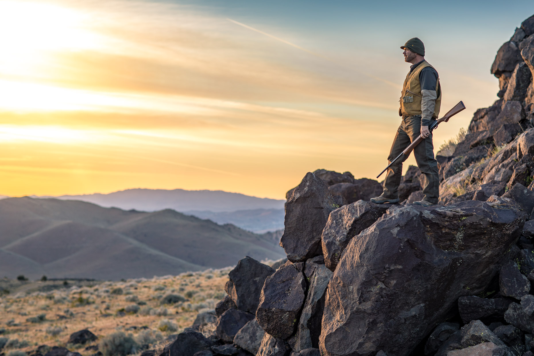 Man walks through the Nevada backcountry hunting Chukar