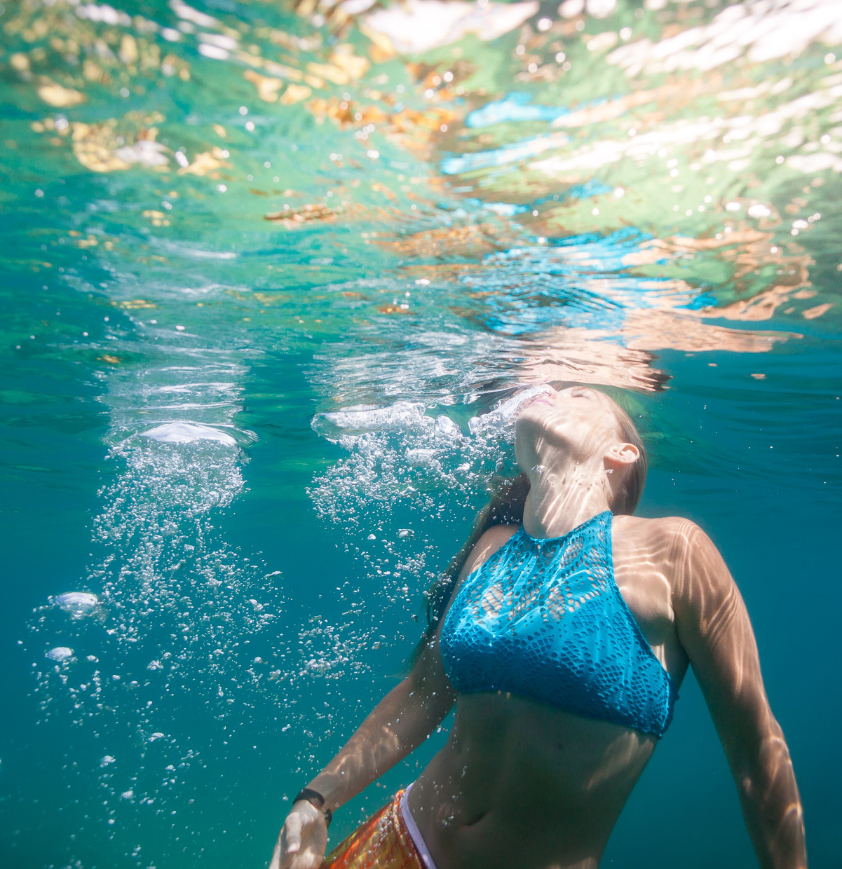 Women swims for the surface of water