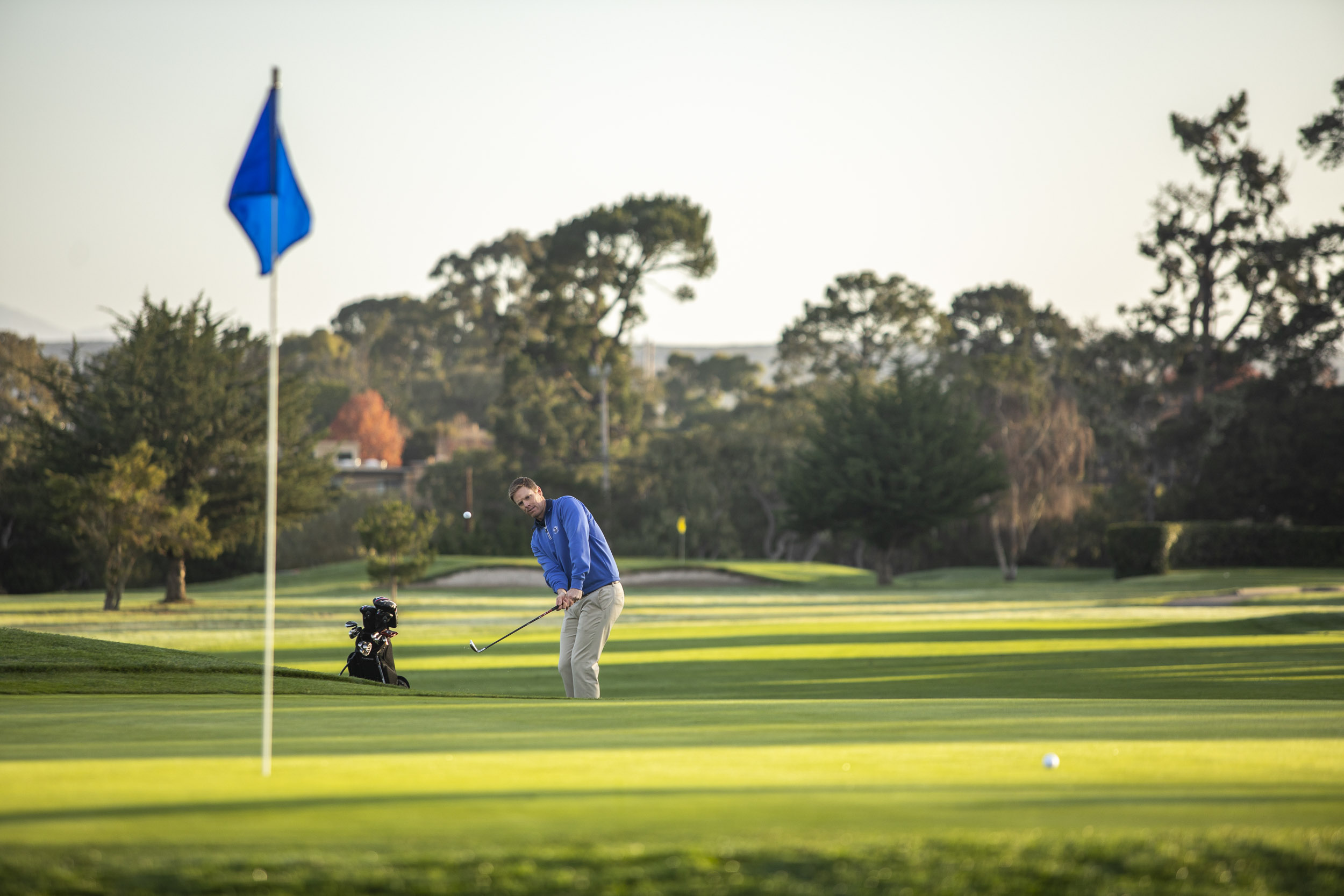 A man makes a chip shot at Del Monte golf Course.